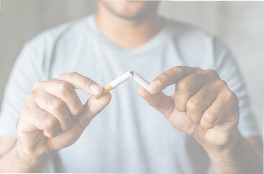 Black and white photo of a Male in a t-shirt breaking a cigarette in half.