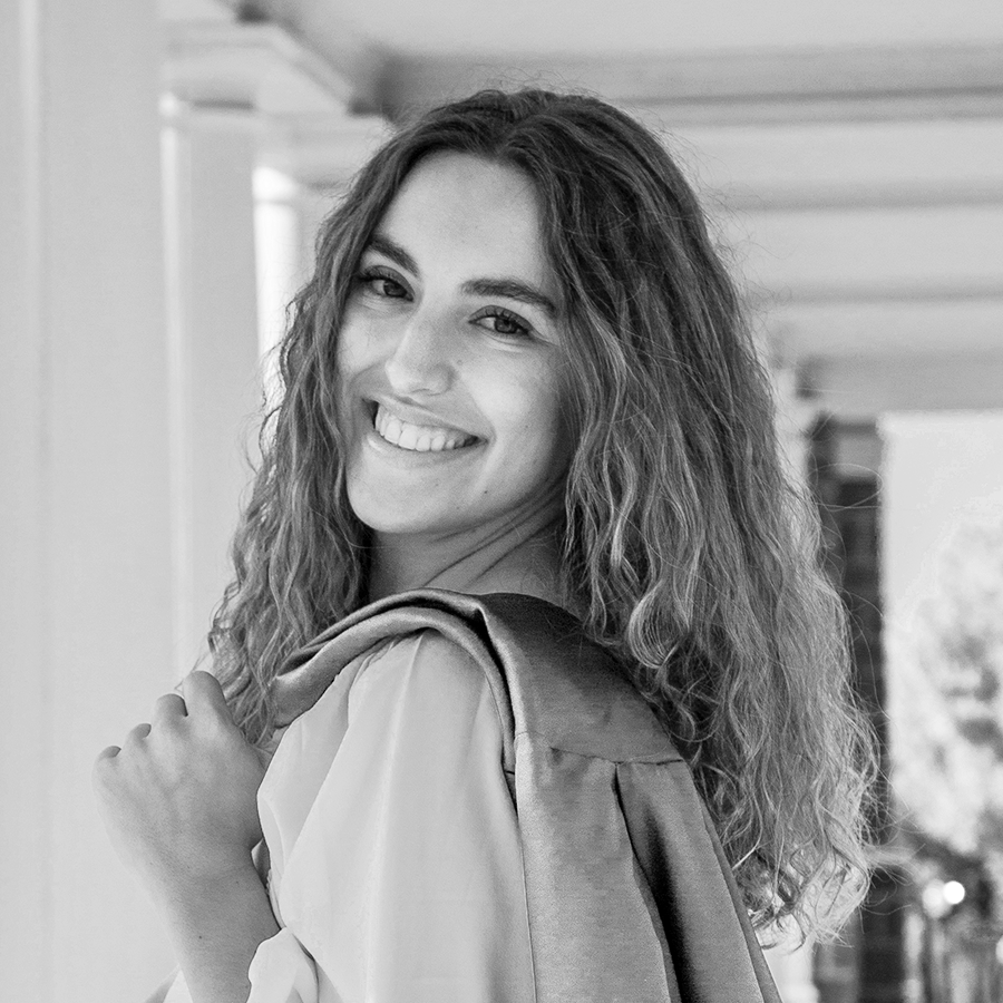 Headshot of Jasmine Kauffeld smiling in monochromatic UVA Blue.